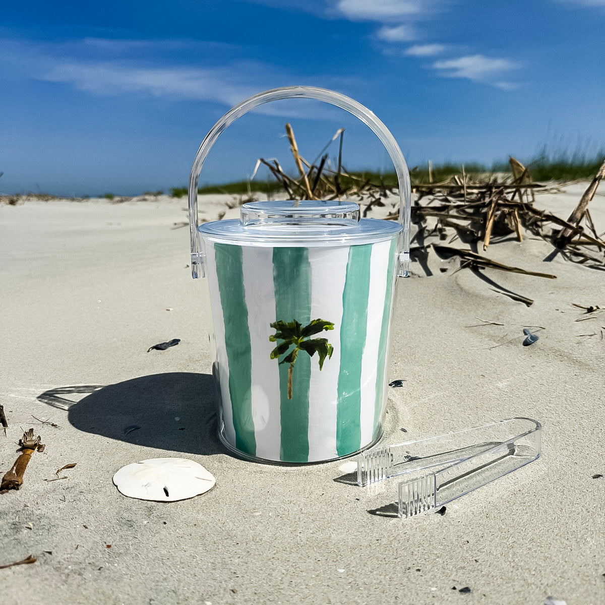 Ice bucket with tongs made from clear Lucite acrylic. Coastal design with removable lid for easy entertaining.