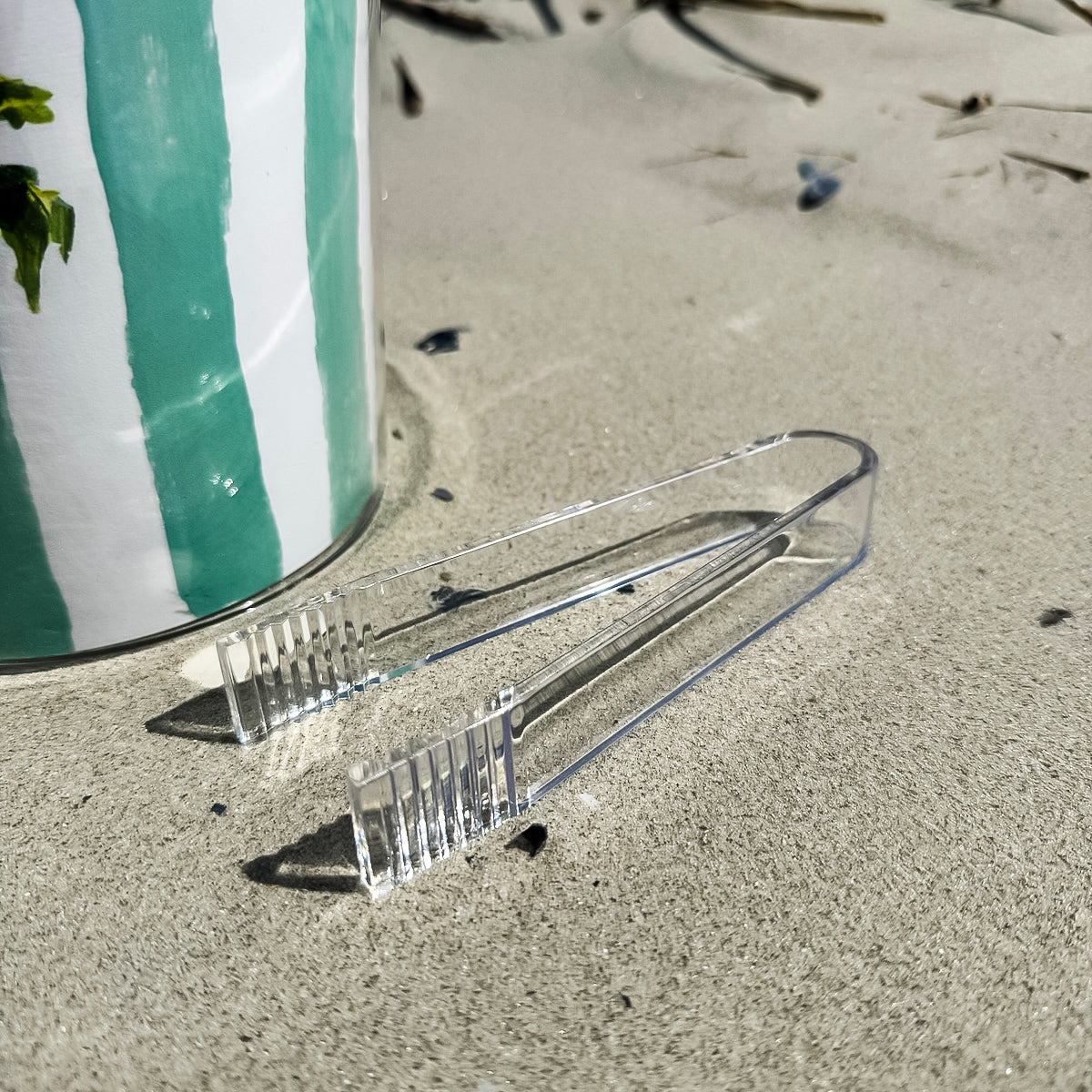 Ice bucket with tongs made from clear Lucite acrylic. Coastal design with removable lid for easy entertaining.