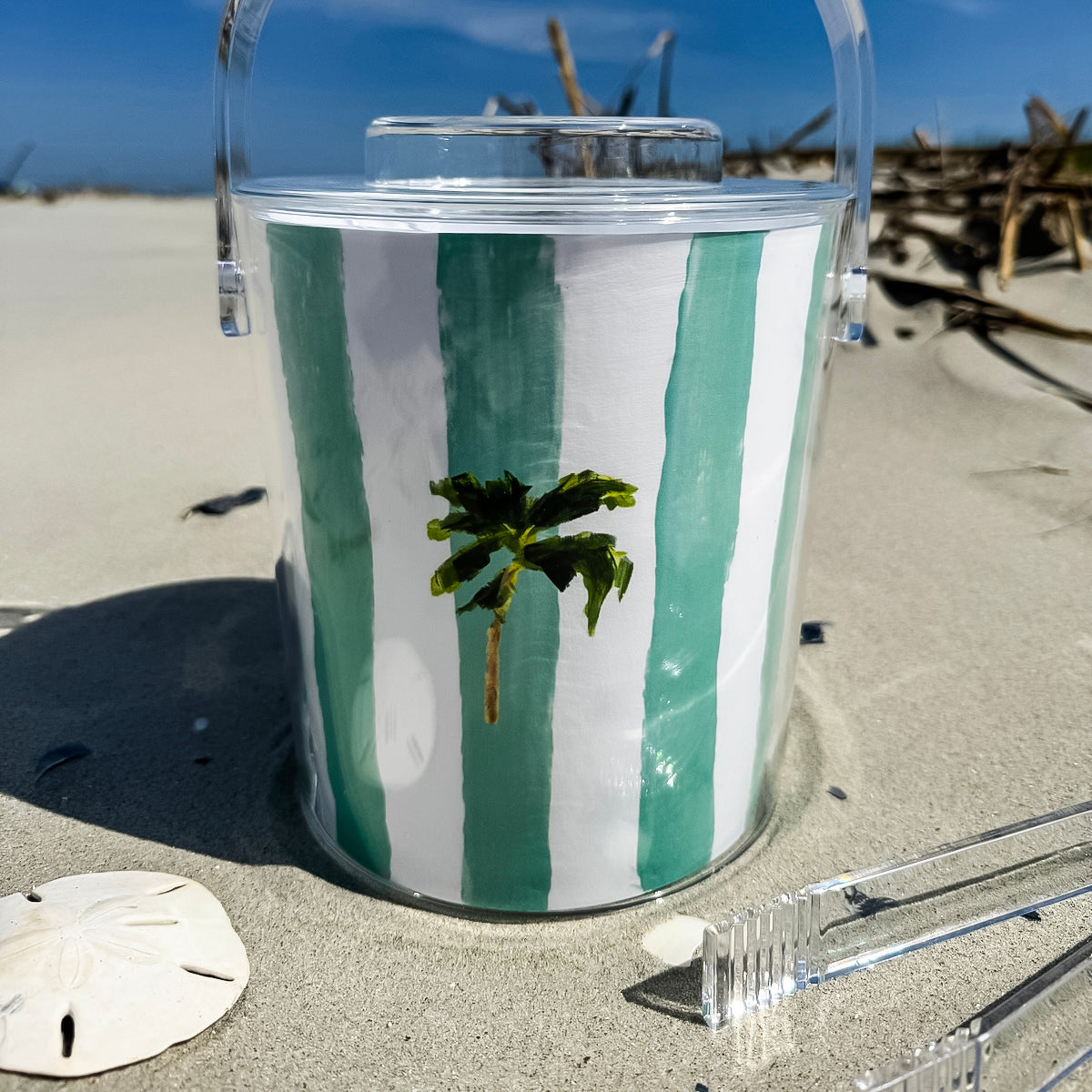 Ice bucket with tongs made from clear Lucite acrylic. Coastal design with removable lid for easy entertaining.