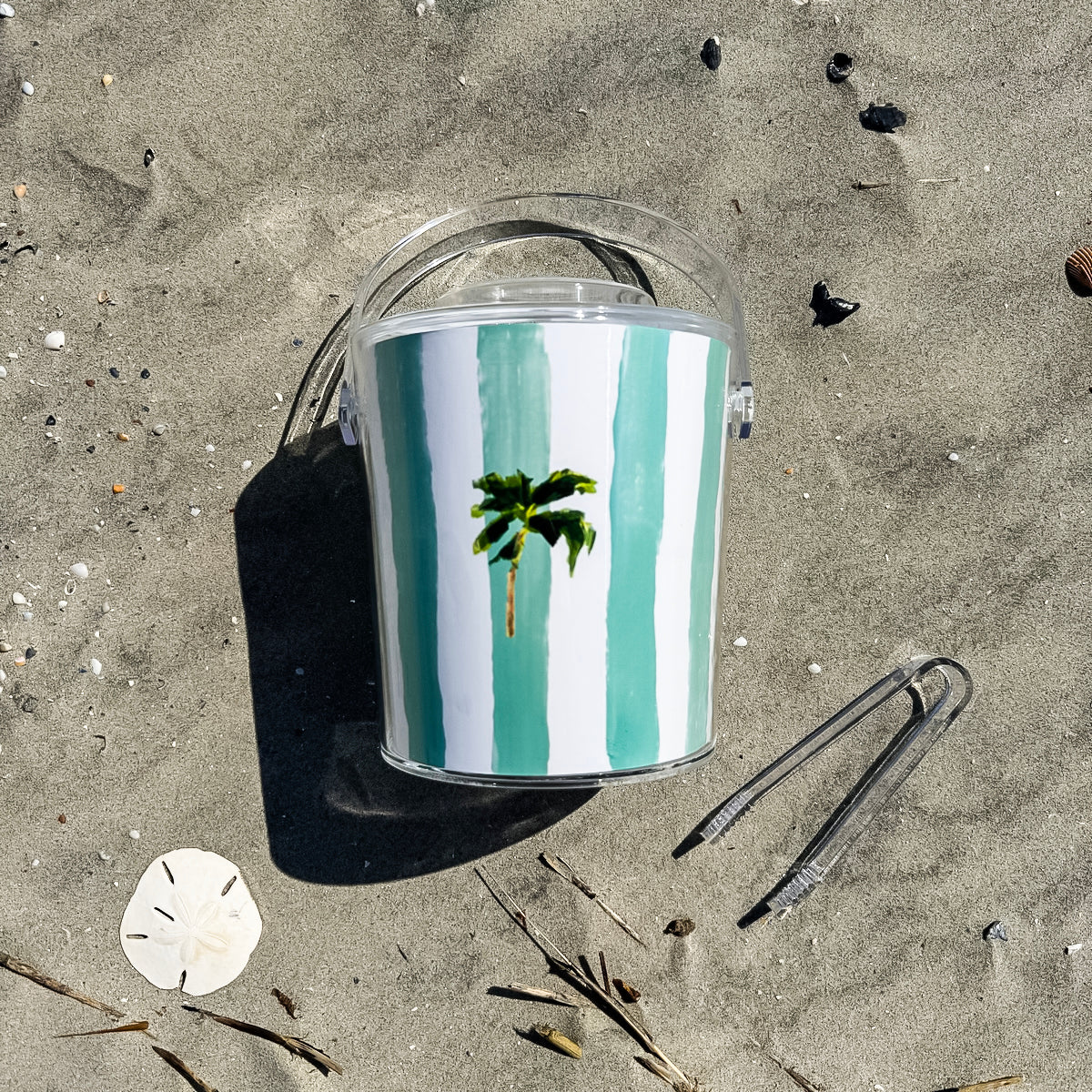 Ice bucket with tongs made from clear Lucite acrylic. Coastal design with removable lid for easy entertaining.