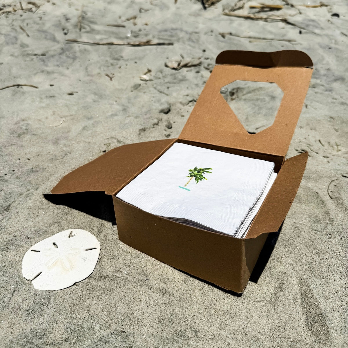 White coastal cocktail napkins, made from soft, three-ply paper with a smooth texture and custom design, are perfect for relaxed entertaining.