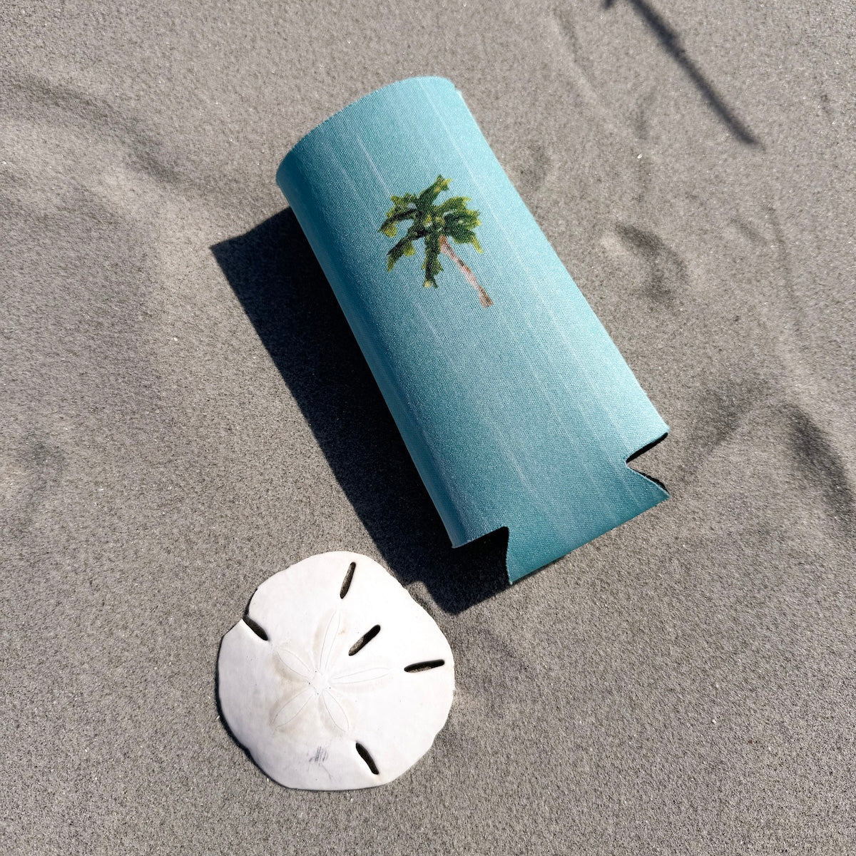 Coastal slim can cooler fits slim 12oz cans. Keeps your drink chill and your vibe coastal.