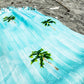 Coastal beach blanket with tassel edges and soft coastal print—your go-to for beach lounging and summer travel.