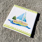 Coastal ceramic coaster with cork backing—square design for hot or cold drinks, easy to clean, and full of coastal charm. Coastal Christmas coaster.