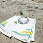 White coastal cocktail napkins, made from soft, three-ply paper with a smooth texture and custom design, are perfect for relaxed entertaining.